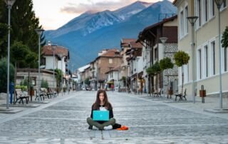 Lady working on road infront of mountains